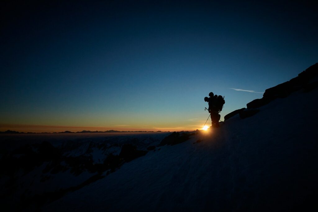 a person standing on top of a snow covered slope